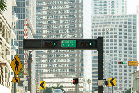 Traffic lights regulating driving cars on city street in Miami, Florida