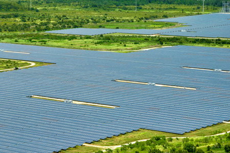 Aerial view of large sustainable electrical power plant with rows of solar photovoltaic panels for producing clean electric energy. Concept of renewable electricity with zero emissionの写真素材