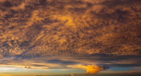 Getting dark at sundown. Sunset sky with scattered clouds of bright colors