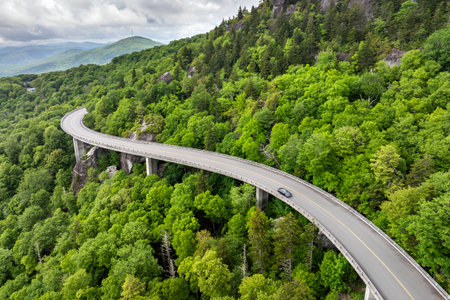 Linn Cove Viaduct on Blue Ridge Parkway road in summer woods of Appalachian mountains with green canopies in colorful forest. Road trip driving in wild nature in summertime seasonの写真素材