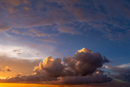 Beautiful sunset sky scenery. Bright colorful orange and yellow clouds on horizonの写真素材