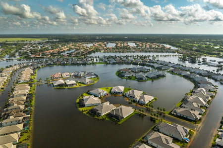 Flooded residential area with underwater houses from hurricane Debby rainfall water in Sarasota, Florida. Aftermath of natural disaster in southern USAの写真素材