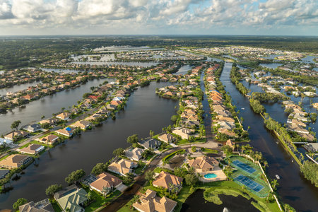 Flooded residential area with underwater houses from hurricane rainfall water in Florida suburban community. Aftermath of natural disaster in southern USAの写真素材