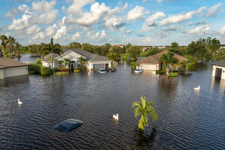Flooded Florida street with stuck car after hurricane Debby rainfall surrounded with water....