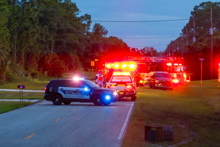 Emergency service personnel responding to potential fire hazard at Florida home. First responders ready to extinguish fire of burning houseの写真素材