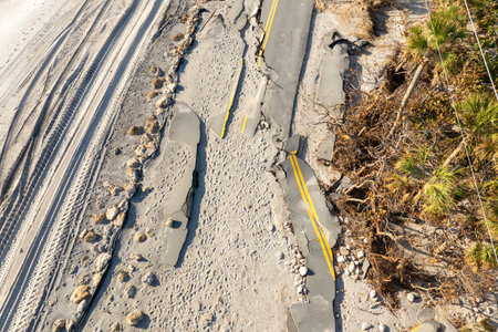 Destroyed Manasota Key road at Blind Pass Beach after Hurricane Milton storm surge. Severe damage to waterfront infrastructure in Floridaの写真素材