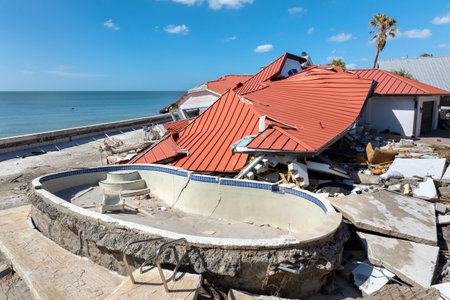 Ruined buildings in need of demolition or repair. Storm surge water and wind damaged houses roof and collapsed walls after hurricane in Floridaの写真素材