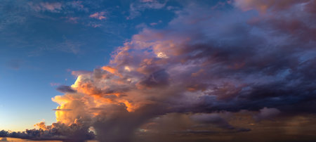 Evening sunset sky with colorful clouds. Panoramic skyscapeの写真素材