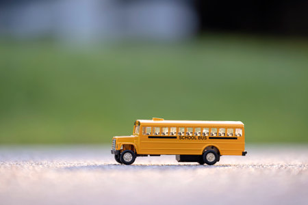 Little model of american yellow school bus outdoor. Concept of education safety in the USAの写真素材