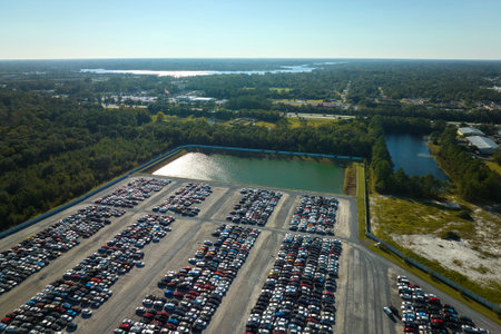 View from above of big parking lot with parked used cars after accident ready for sale. Auction reseller company selling secondhand broken vehicles for repairの写真素材