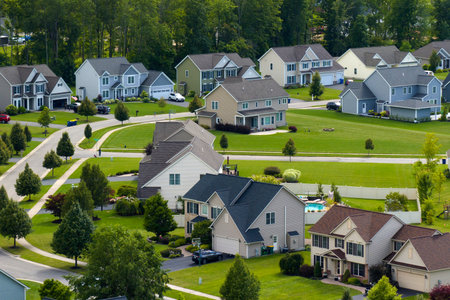 Low-density two story private homes in rural residential suburbs outside of Rochester, New York. Upscale suburban houses with large lot size and green grassy lawns in summer seasonの写真素材