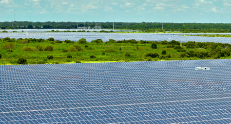 Aerial view of big sustainable electric power plant with many rows of solar photovoltaic panels for producing clean electrical energy. Renewable electricity with zero emission conceptの写真素材