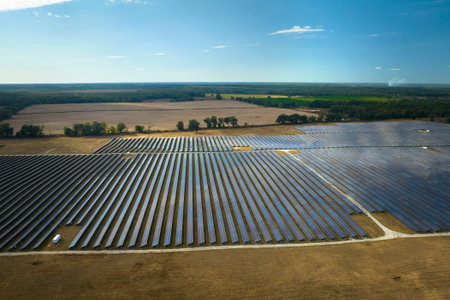 Aerial view of big sustainable electric power plant with many rows of solar photovoltaic panels for producing clean electrical energy. Renewable electricity with zero emission conceptの写真素材