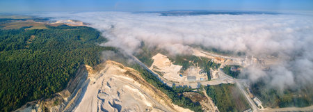 Aerial view of open pit mining of limestone materials for construction industry with excavators and dump trucksの写真素材
