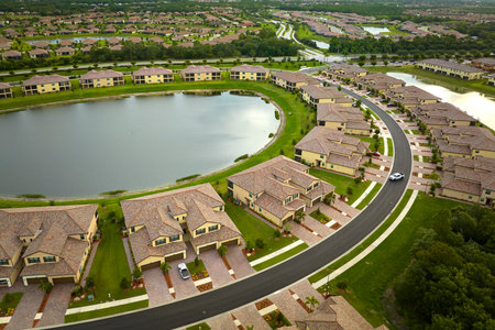 Aerial view of tightly located family houses with retention ponds to prevent flooding in Florida closed suburban area. Real estate development in american suburbsの写真素材