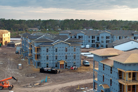 Aerial view of unfinished wooden frames of apartment buildings under construction. Development of residential housing in American suburbs. Real estate market in the USAの写真素材