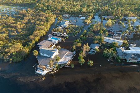 Aftermath of natural disaster. Surrounded by hurricane rainfall flood waters homes in Florida residential areaの写真素材