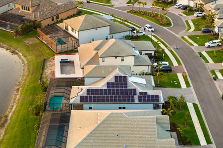 American building roof with rows of blue solar photovoltaic panels for producing clean ecological electric energy. Renewable electricity with zero emission conceptの写真素材