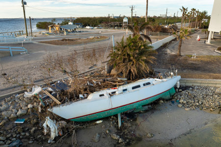Capsized yachts left forsaken on shore after hurricane Milton on Manasota Key in Englewood, Floridaの写真素材