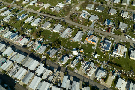 Destroyed by hurricane strong winds suburban houses in Florida mobile home residential area. Consequences of natural disasterの写真素材