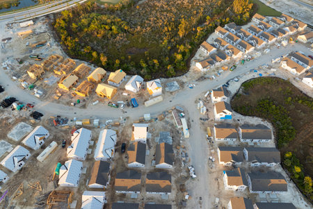 Development of residential housing in the USA. Wooden frames of new cheap American homes under constructionの写真素材