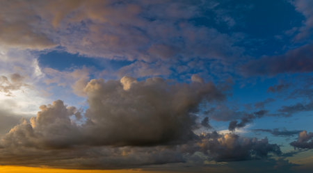 Dramatic sunset sky covered with colorful clouds. Panoramic skyscapeの写真素材