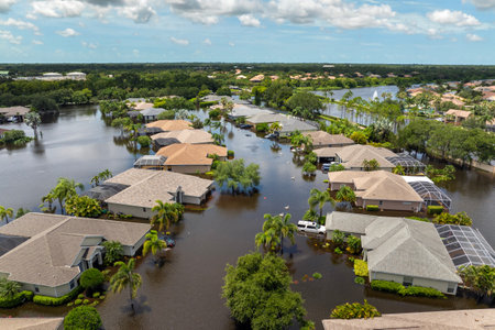 Flooding in Florida caused by tropical storm from hurricane Debby. Suburb houses in Laurel Meadows residential community surrounded by flood waters in Sarasota. Aftermath of natural disasterの写真素材