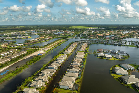 Flooding in Florida caused by tropical storm from hurricane Debby. Suburb houses in residential community surrounded by flood waters in Sarasota. Aftermath of natural disasterの写真素材