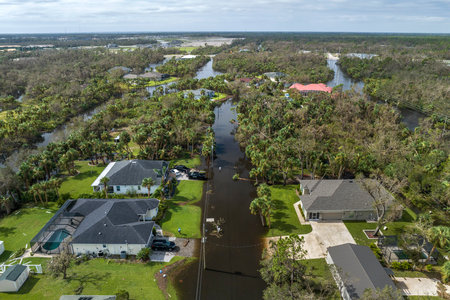 Heavy flood with high water surrounding residential houses after hurricane Ian rainfall in Florida residential area. Consequences of natural disasterの写真素材