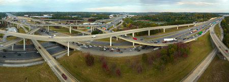 American freeway intersection with fast driving cars and trucks. View from above of USA...