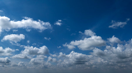 Blue sky with white summer rain clouds. Colorful summer landscapeの写真素材
