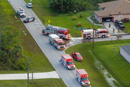 First responders at potential fire hazard at Florida home. Firefighter trucks at fire alarm scene of...