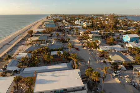 Ruined buildings in need of demolition or repair. Storm surge water and wind damaged houses roof and collapsed walls after hurricane in Floridaの写真素材