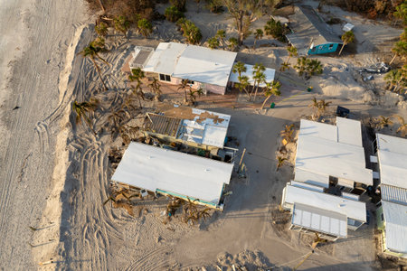 Storm surge caused by hurricane wind severe damaged residential houses on ocean shore. Natural disaster consequences in Floridaの写真素材