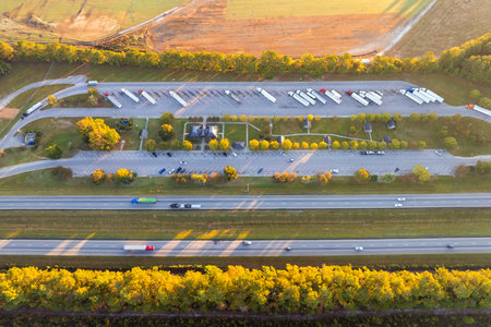 Truck stop at multilane American freeway. Rest area for semi-truck lorry vehicles. Resting place during interstate traveling in USAの写真素材