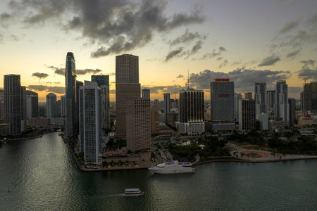 View from above of high skyscraper buildings in downtown district of Miami Brickell in Florida, USA at sunset. American megapolis with business financial district at nightfallの写真素材