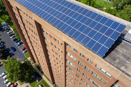 Photovoltaic panels on solar rooftop of condo building for producing clean ecological electrical energy. Renewable electricity with zero emission conceptの写真素材