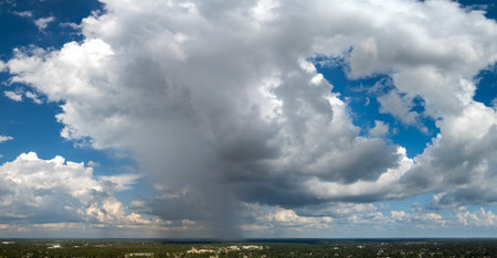 Rain shower water pouring down from stormy clouds during summer thunderstorm in Floridaの写真素材