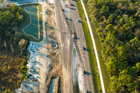 Roadworks construction site on American highway. Development of city transportation crossroadsの写真素材