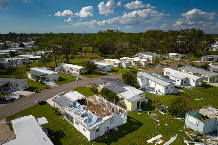 Severely damaged houses after hurricane Ian in Florida mobile home residential area. Consequences of natural disasterの写真素材