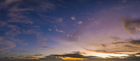 Sunset sky with bright colorful orange and yellow clouds. Panoramic skyscapeの写真素材