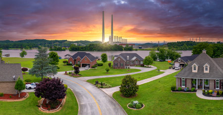 Thermal power plant polluting air burning coal fossil fuel for production of electrical energy. Private residential houses at Kingston power station in Roane County, Tennesseeの写真素材
