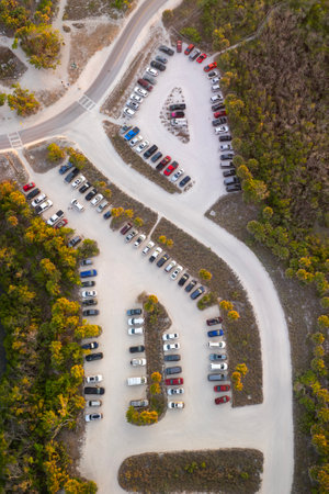 Vehicle parking area with cars parked on ocean beach parking lot at sunset. Summer vacation on beachfront in Southern Floridaの写真素材