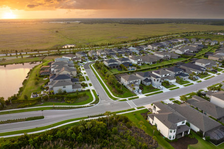 Expensive mansions between green palm trees in southwest Florida suburbs, USA. Aerial view of wealthy residential neighborhoodの写真素材
