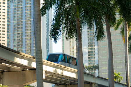 Public transportation in downtown Miami in Florida USA. Metrorail city train car on high railroad...