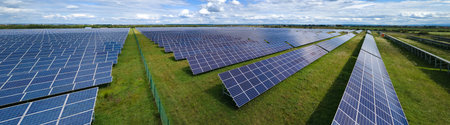 Aerial view of large sustainable electrical power plant with rows of solar photovoltaic panels for...