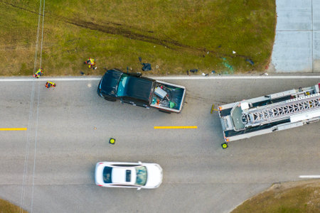 Car accident on highway road in Florida. Emergency services personnel helping victims of vehicle...