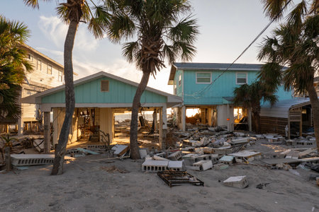 Ruined buildings in need of demolition or repair. Storm surge water and wind damaged houses roof and...