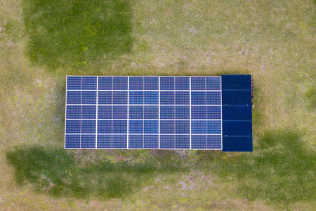 Solar photovoltaic panels mounted on stand-alone frame on backyard ground for generating of clean...