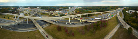 Aerial view of american freeway intersection with fast moving cars and trucks. USA transportation...